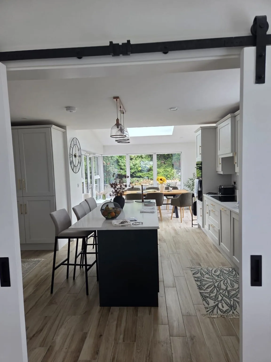 Kitchen and dining room seen through a sliding barn door