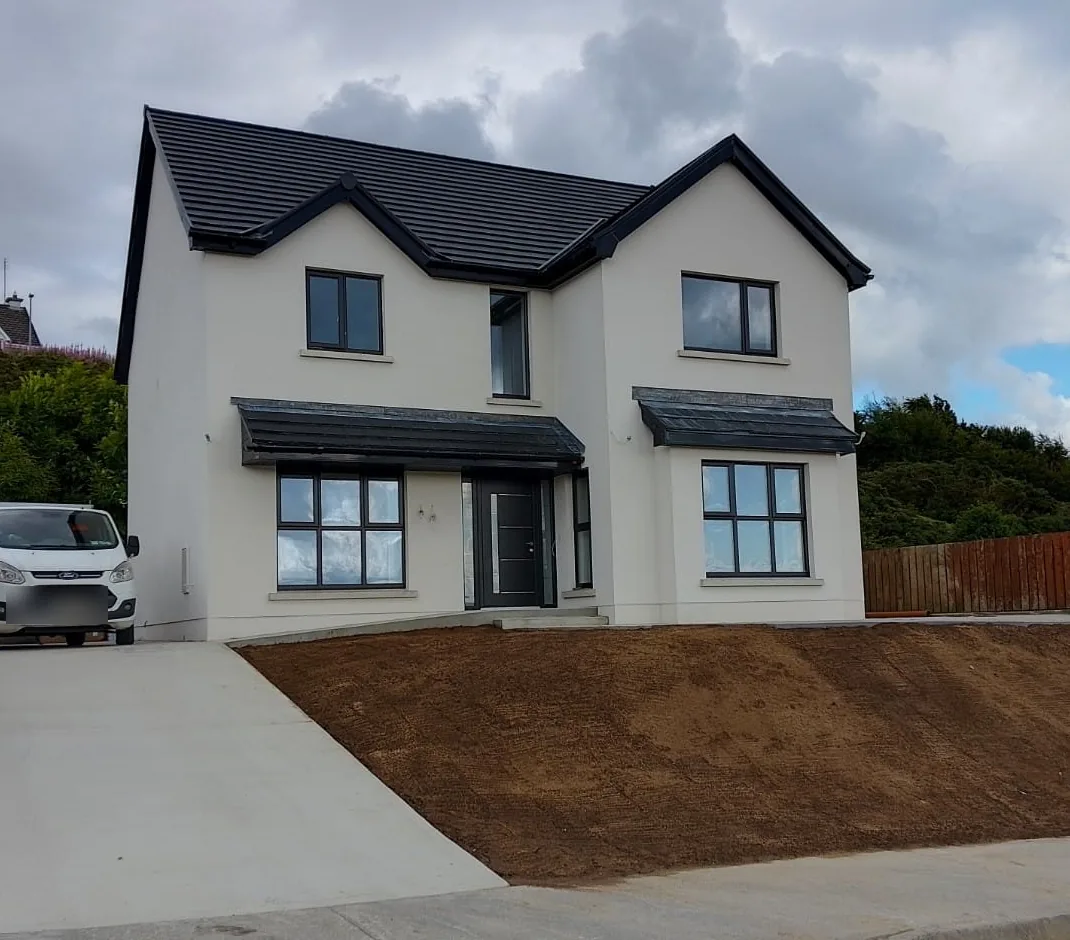 Finished two storey new build by Don Contracts, white render with a dark tiled roof